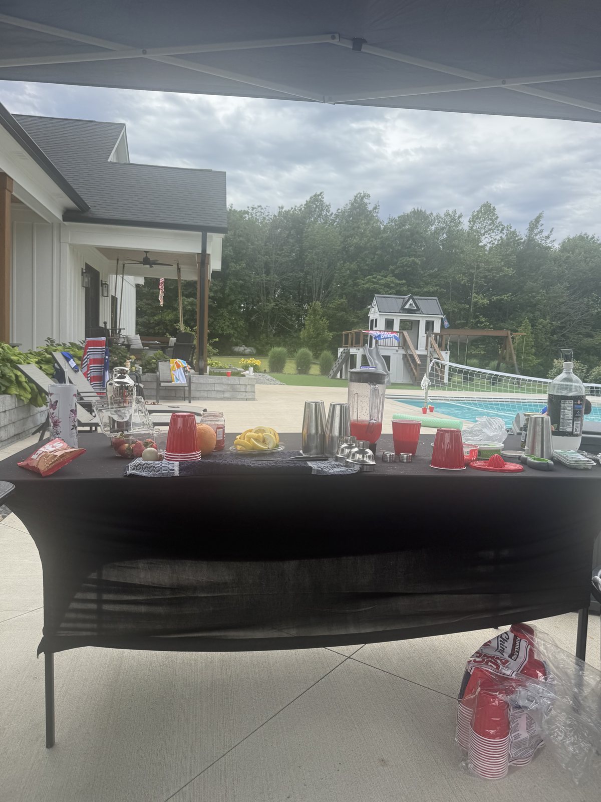 A full mobile bar spread of cocktails, garnishes and tools poolside
