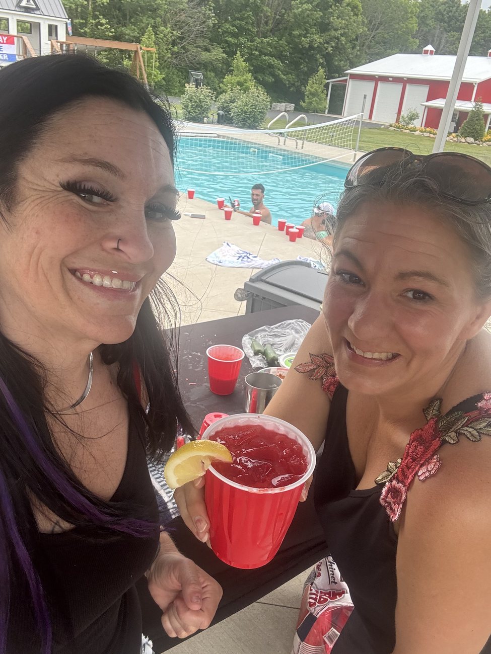 Mandy and a guest toasting fresh cocktails at a party