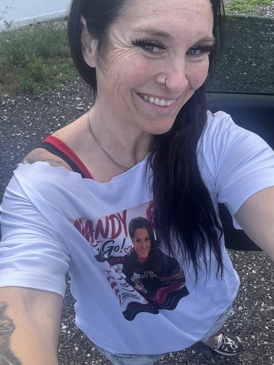 Mandy, mobile bartender and karaoke host, smiling in her Mandy on the Go shirt