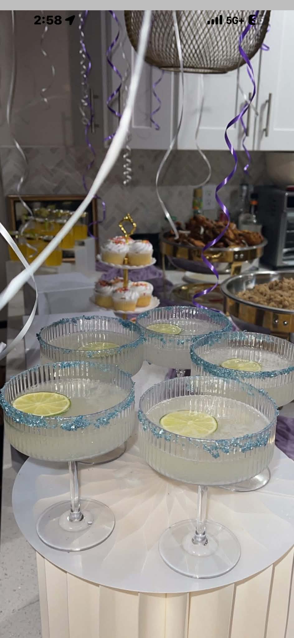 Coupe margaritas with blue sugar rims