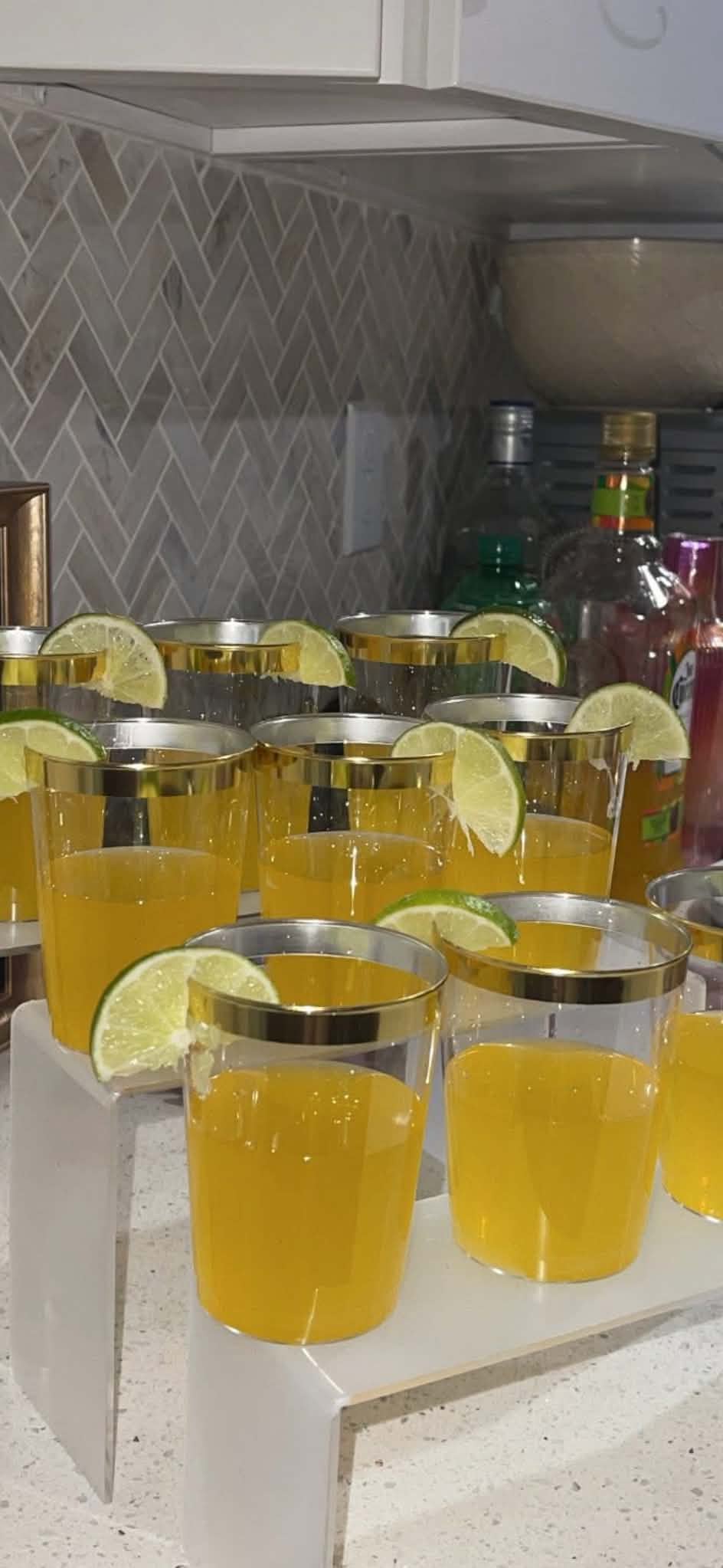 Gold-rimmed margaritas with fresh lime wedges